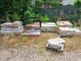 a pile of mattresses and a toilet in the yard