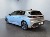 the rear end of a silver car in a white room