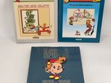 two books on a white surface one is a cartoon and the other is a comic