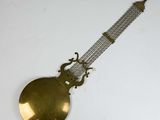 a clock that is hanging on the wall with a chain around it