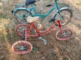 two bicycles that are parked in the grass