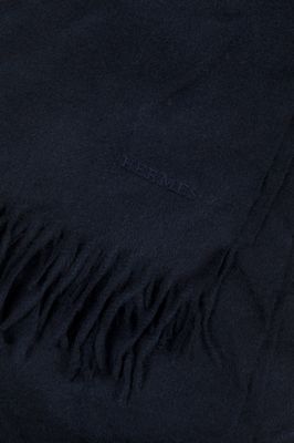 a close up of a black blanket with a fringe on it
