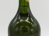 bottles of wine are lined up in a row on a white surface