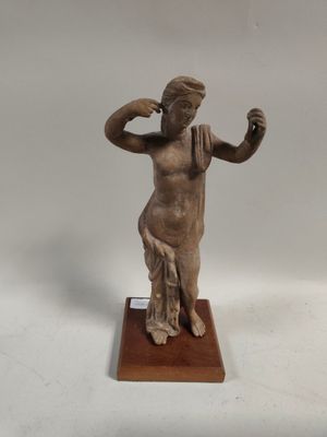 statue of a woman holding a glass of wine on a wooden base