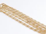 a close up of a gold chain bracelet on a white surface