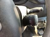 a close up of a steering wheel with a remote control