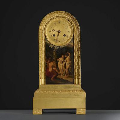 an image of a gold clock with a painting on it