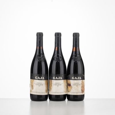 three bottles of wine sitting on top of a table next to each other