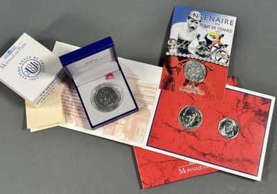 two silver coins and a booklet are on a table