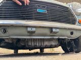 a close up of a person touching the front of a car