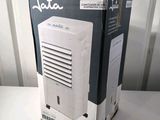 a box with a white air conditioner inside of it