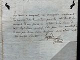 an old piece of paper with writing on it sitting on a table