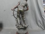 a bronze statue of a man with a bow and arrow