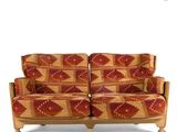 an image of a red and yellow patterned couch with wooden legs