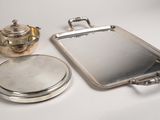 a silver tray with a mirror and a teapot