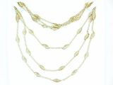 gold chain necklace with leaves and beads on a white background