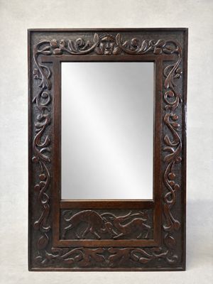 an old wooden mirror with a carved frame on a white background