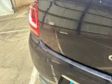 a black car parked in a parking lot next to a building