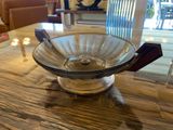 a glass bowl sitting on a wooden table with candles