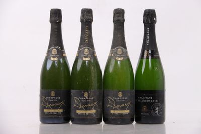 three bottles of champagne are lined up on a table