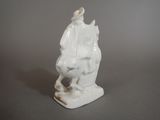 a figurine of a man sitting on a horse