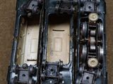three toy trains sitting side by side on the floor