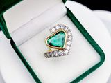 an image of a heart shaped emerald and diamond ring in a green velvet box
