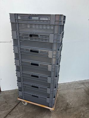 several plastic crates stacked on top of each other in a garage
