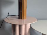 a table with a lamp on top of it next to a table with a lamp on it