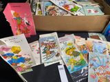 a box full of children ' s cards and a pair of scissors