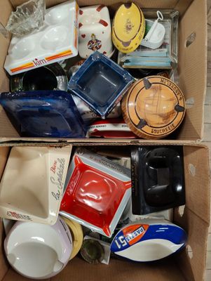 a cardboard box filled with assorted coffee cups and mugs