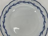 a close up of a blue and white plate on a table