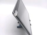 a tablet computer sitting on a stand on a white surface