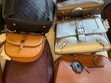 a lot of purses that are sitting on a table