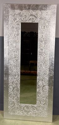 a mirror that is sitting on the floor in a room