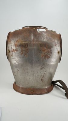 a metal pot with a handle on a white surface