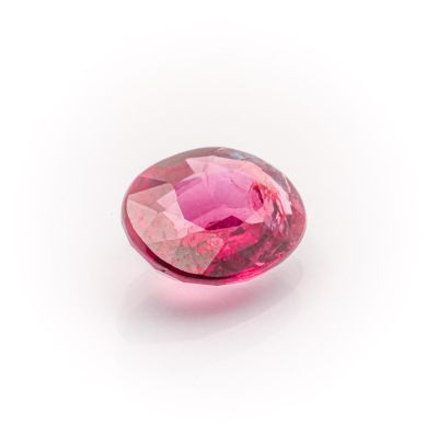 a close up of a pink diamond on a white surface