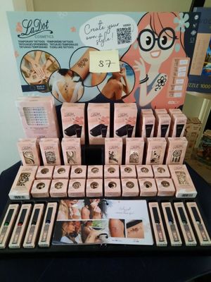 a close up of a display of makeup products on a table