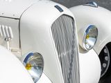 a close up of the front end of a white car