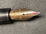 a close up of a fountain pen on a table
