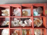 a wooden box filled with many different types of perfumes