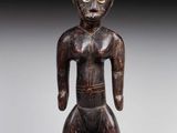 a wooden statue of a man with a hat on his head
