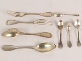 a lot of silver spoons and forks on the table