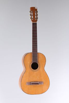 an image of a guitar hanging from a string on a wall