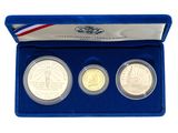a set of three commemorative coins in a blue case