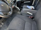 the interior of a van with the driver ' s seat folded down