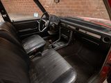 a red car with black leather seats and a steering wheel