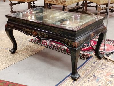 a coffee table with a glass top on a rug in a room
