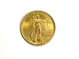 a close up of a gold coin on a white surface