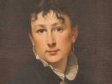 portrait of a woman in a black coat and white collared shirt